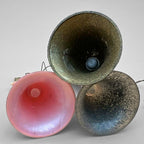 Underside view of vintage angel bell ornaments showing interior bell structure. Pink, silver, and gold bells reveal authentic construction and age wear. Mid century German Christmas decor collectible set