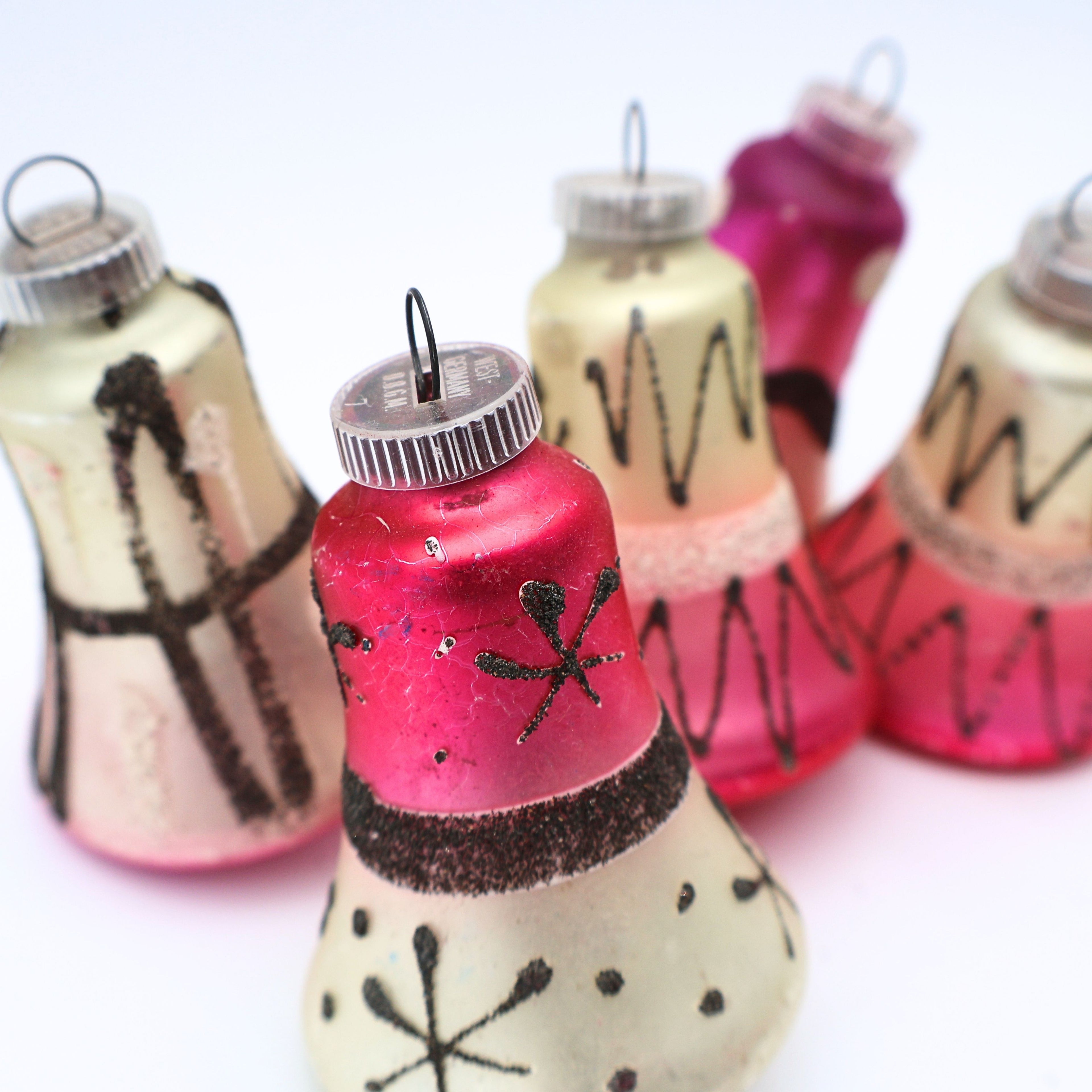 Styled grouping of vintage West Germany atomic bell ornaments with mercury glass finishes and black glitter details
