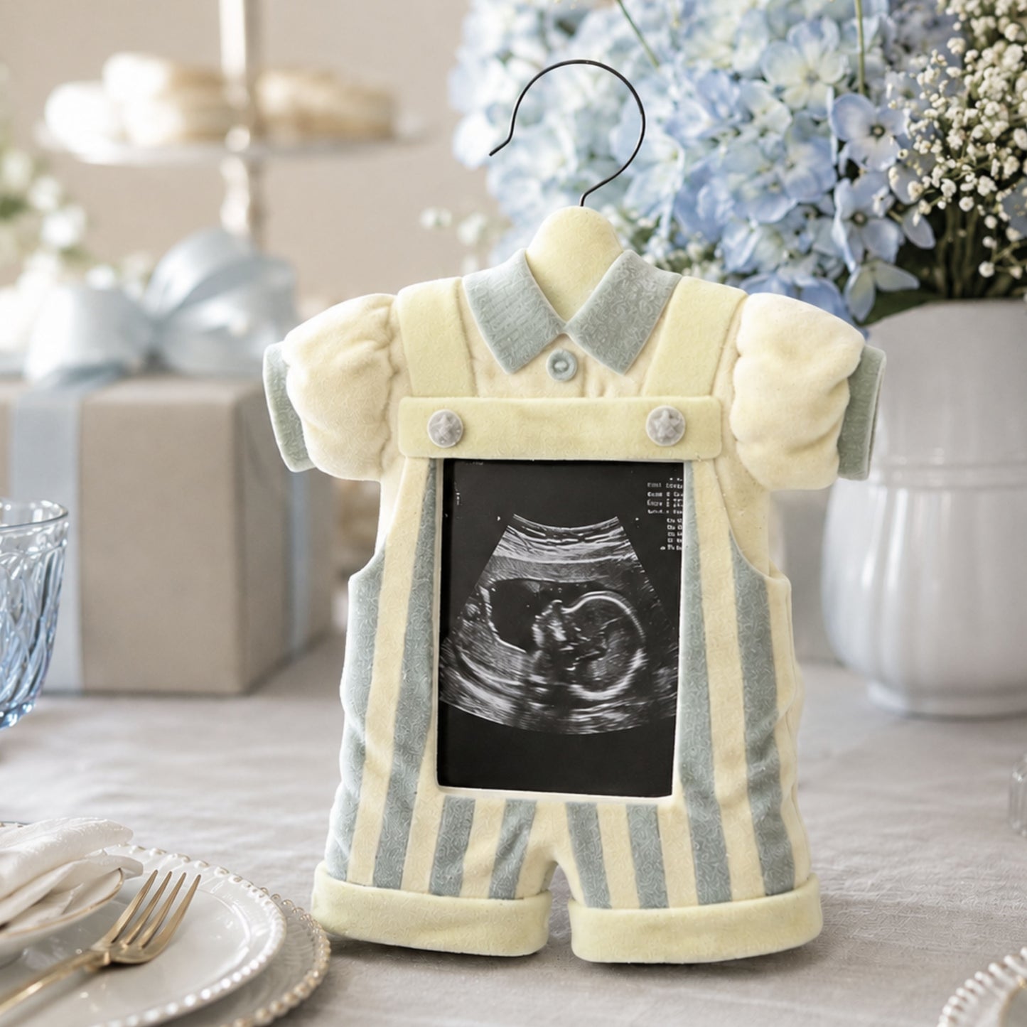 Vintage Baby Boy Picture Frame Nursery Decor displayed at elegant gender reveal table with ultrasound photo pastel blue hydrangeas linen tablecloth and luxury baby shower keepsake styling by Heart & Home Connoisseur