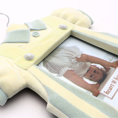 Angled detail view of vintage baby boy picture frame showing dimensional romper styling pastel nursery colors and soft flocked resin texture finish