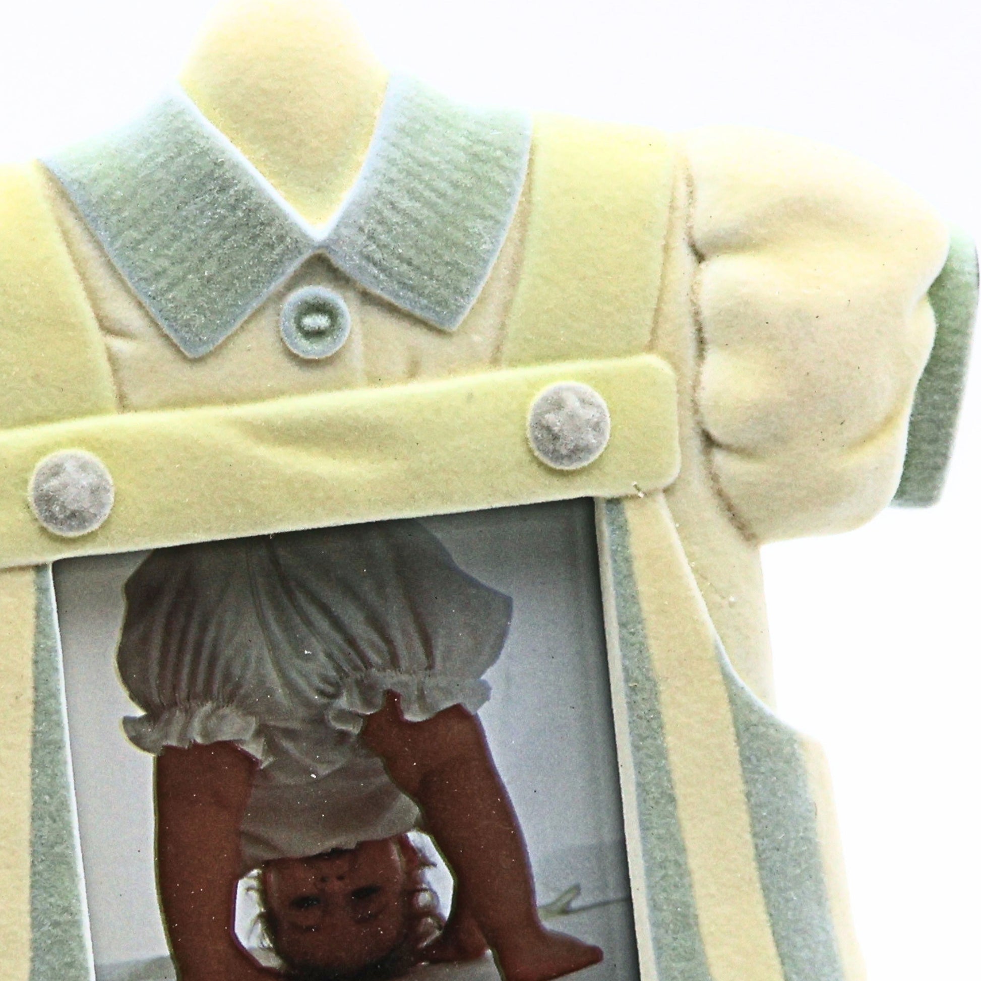 Closeup detail of vintage baby boy picture frame featuring pastel blue collar dimensional buttons flocked resin texture and heirloom inspired nursery decor styling