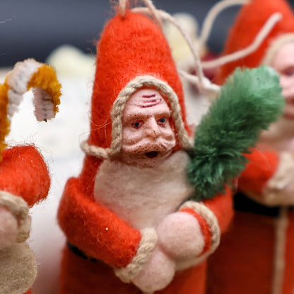 Close-up of vintage Belsnickle Santa ornaments showing spun cotton texture and handmade facial detail