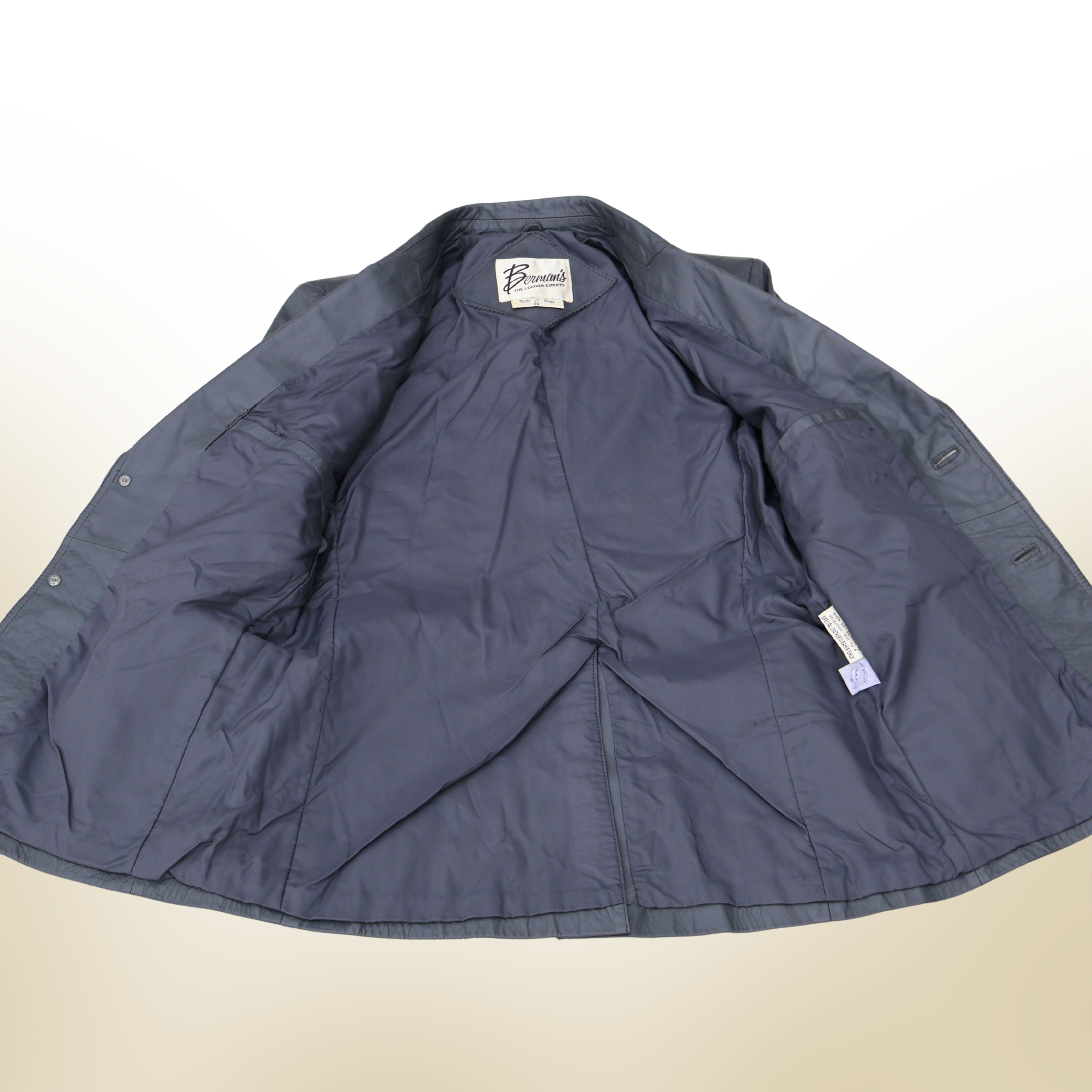 Interior lining of vintage gray leather blazer fully opened to show condition and stitching.