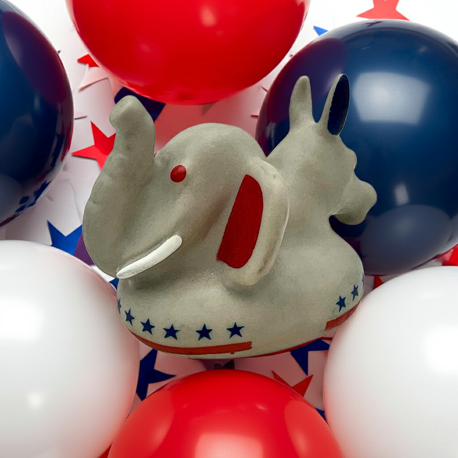 Vintage bipartisan donkey elephant squeak toy ASI 37170 surrounded by red white and blue balloons, featuring rare political novelty design with Democrat donkey and Republican elephant combined. Retro rubber squeeze toy collectible, patriotic Americana decor piece, mid century novelty gift for political collectors and vintage toy enthusiasts.