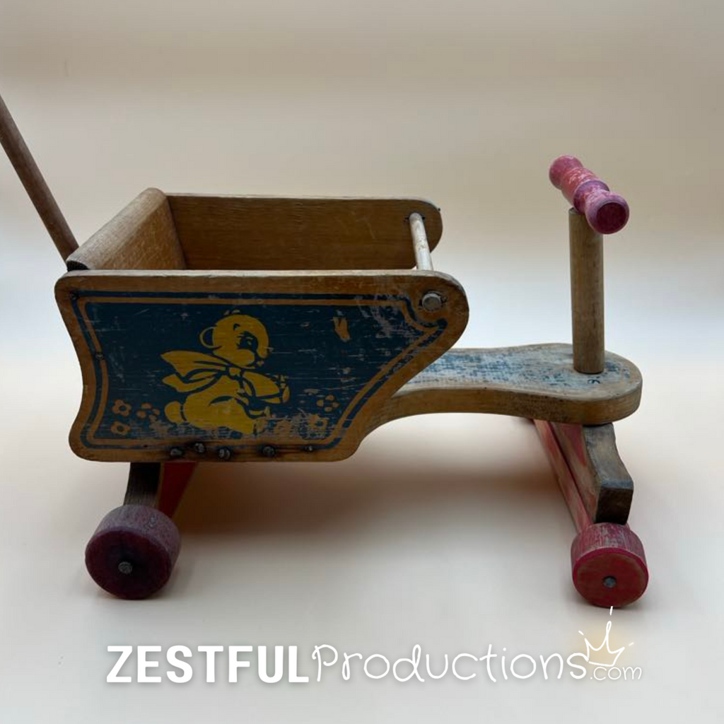 Opposite side of the vintage wooden doll stroller displaying the original blue bear artwork, natural wood finish, red painted wheels, and classic mid-century American toy design.