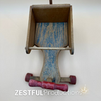 Top-front view looking into the wooden storage compartment of the 1950s Cass Toys doll push cart, highlighting the original painted floor, removable front steering handle, and sturdy handcrafted construction.