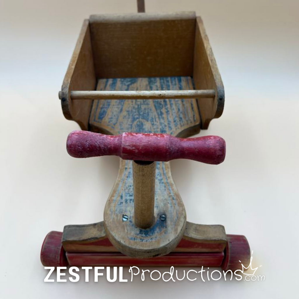 Overhead view of the doll compartment inside the vintage Cass Toys push cart showing original painted wood grain, interior construction, and handcrafted details preserved from decades of gentle use.