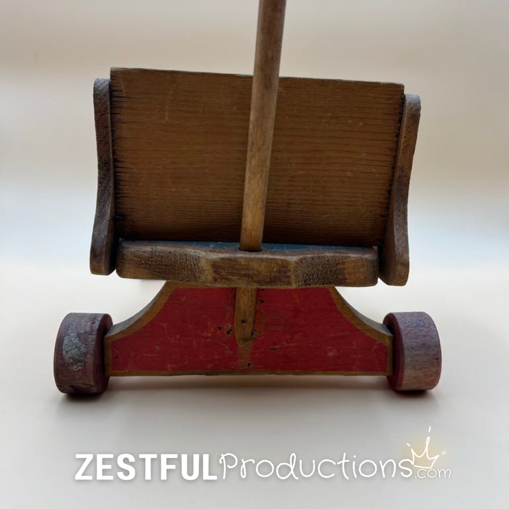 Rear view of the vintage Cass Toys wooden doll push cart highlighting the tall push handle, solid wood construction, original painted base, and authentic vintage wear throughout the piece.
