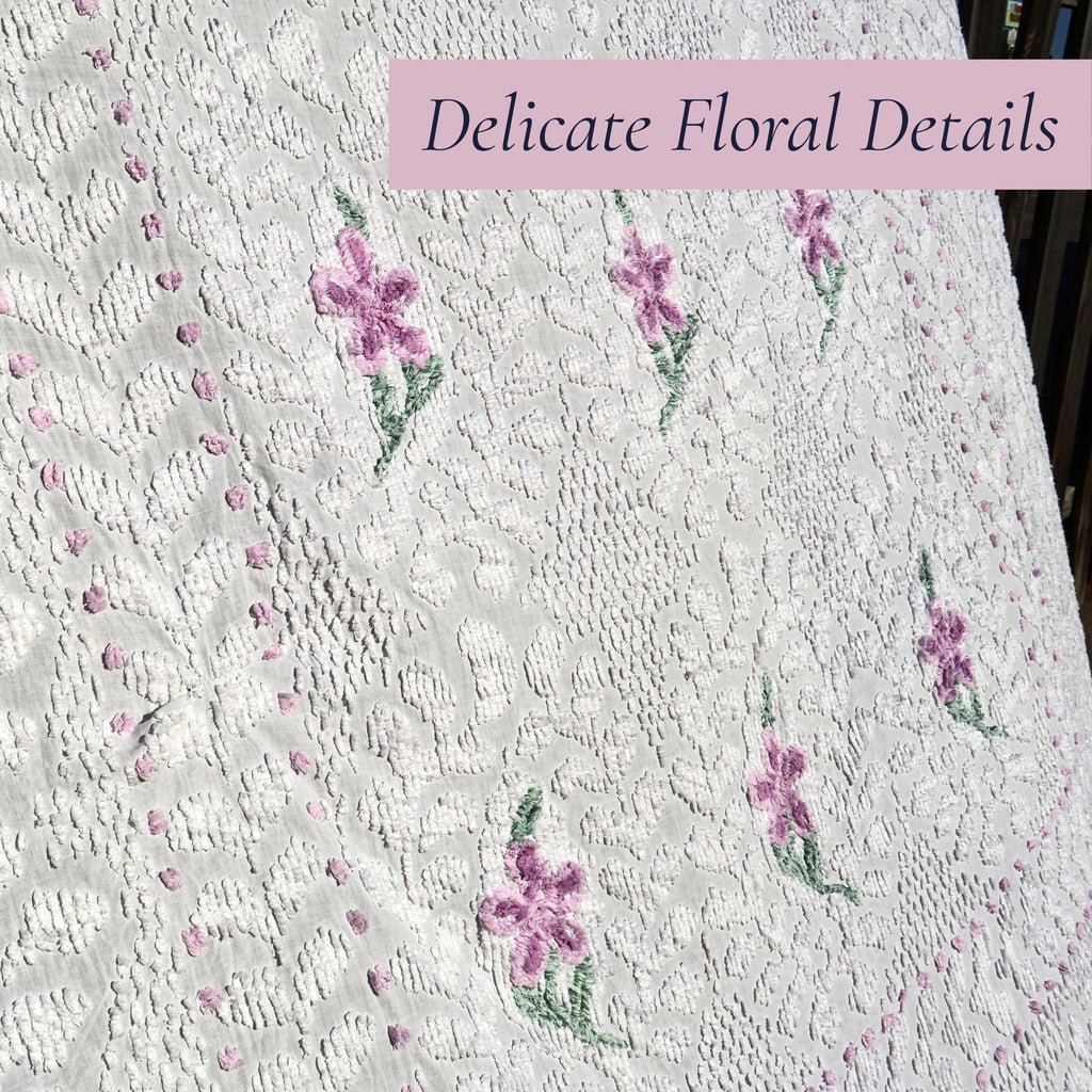 Close-up of the lavender floral embroidery on a vintage white chenille bedspread, highlighting the intricate hand-tufted craftsmanship and raised texture. Perfect inspiration for cottage decor, farmhouse bedding, vintage bedroom styling, and heirloom textile collectors.