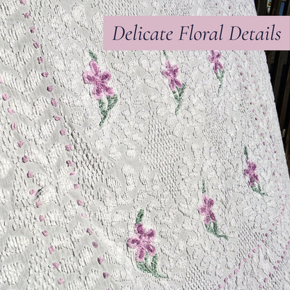 Close-up of the lavender floral embroidery on a vintage white chenille bedspread, highlighting the intricate hand-tufted craftsmanship and raised texture. Perfect inspiration for cottage decor, farmhouse bedding, vintage bedroom styling, and heirloom textile collectors.
