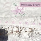 Detailed view of the original decorative fringe on a vintage white chenille bedspread. The handcrafted edge finish adds texture and authentic vintage charm, making this heirloom textile a beautiful addition to cottage decor, farmhouse bedrooms, and shabby chic interiors.
