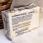 Rear angled view of a vintage Crystal White Family Soap bar highlighting its original paper wrapper, aged folds, and decades of authentic storage wear. A unique Colgate-Palmolive advertising collectible that adds nostalgic character to vintage laundry room decor, photography styling, and farmhouse displays.