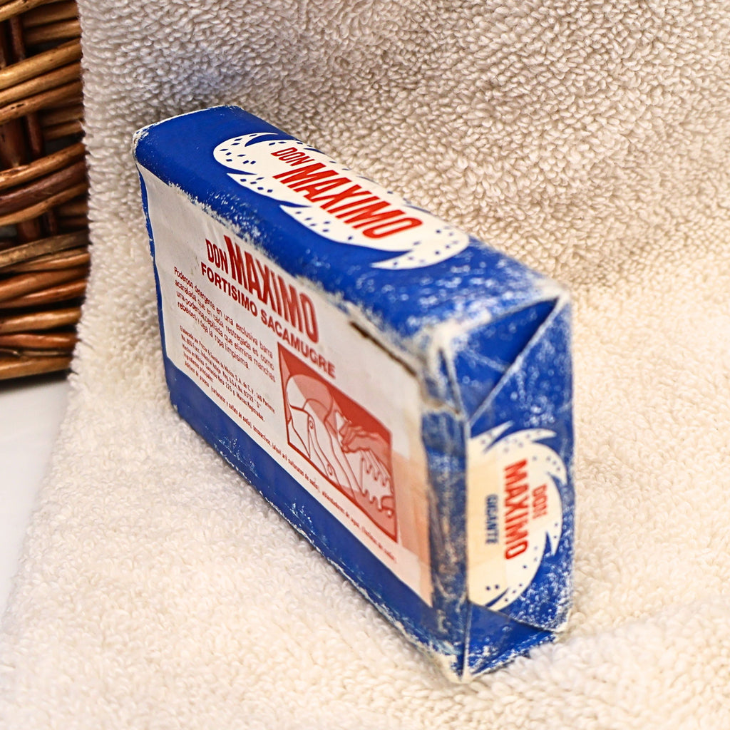 Side view of an original Don Maximo Laundry Soap bar showing its vintage printed wrapper, folded packaging, and authentic age-related wear. A unique Procter & Gamble de Mexico advertising collectible perfect for vintage decor, general store displays, laundry room styling, and retro household collections.