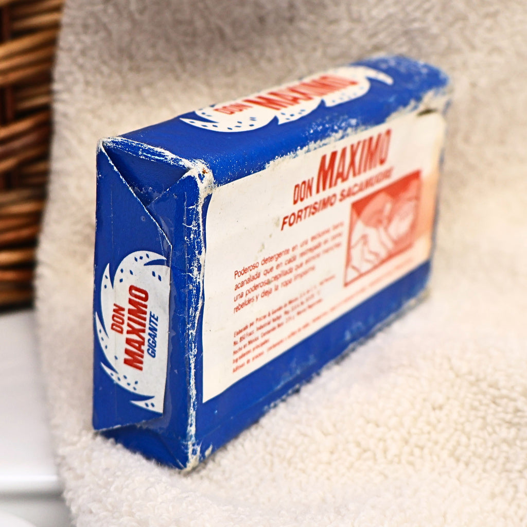 Opposite side of a vintage Don Maximo Laundry Soap bar featuring colorful Spanish branding and original paper packaging from Procter & Gamble de Mexico. This nostalgic advertising collectible adds character to farmhouse decor, vintage laundry displays, Americana collections, and photography props.