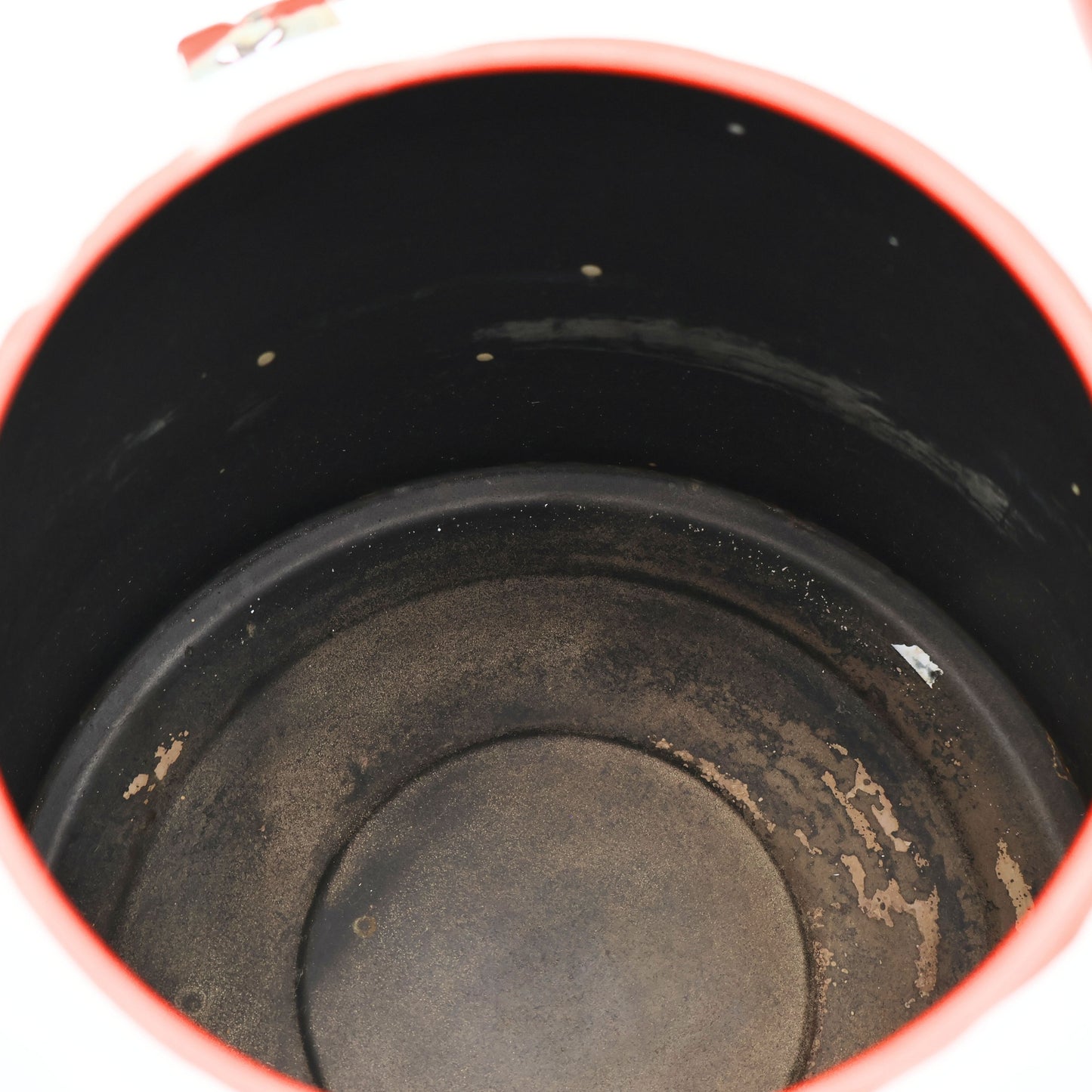 Interior of antique enamel coffee kettle showing aged patina and authentic vintage wear