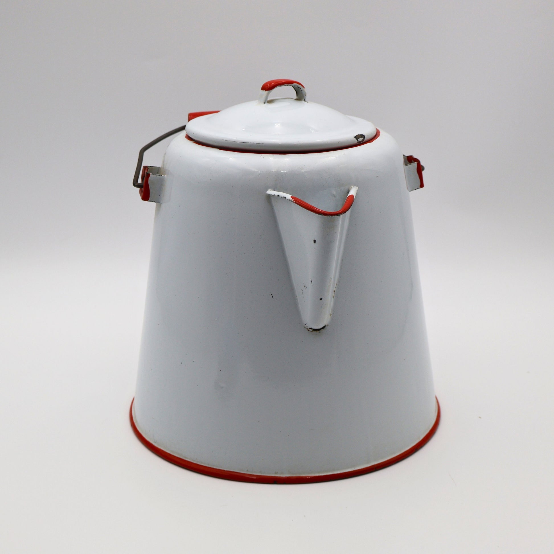 Side view of vintage enamel coffee pot showing red trimmed spout and classic ranch styling