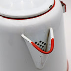 Detail view of vintage enamel coffee pot showing red trimmed spout and classic ranch styling