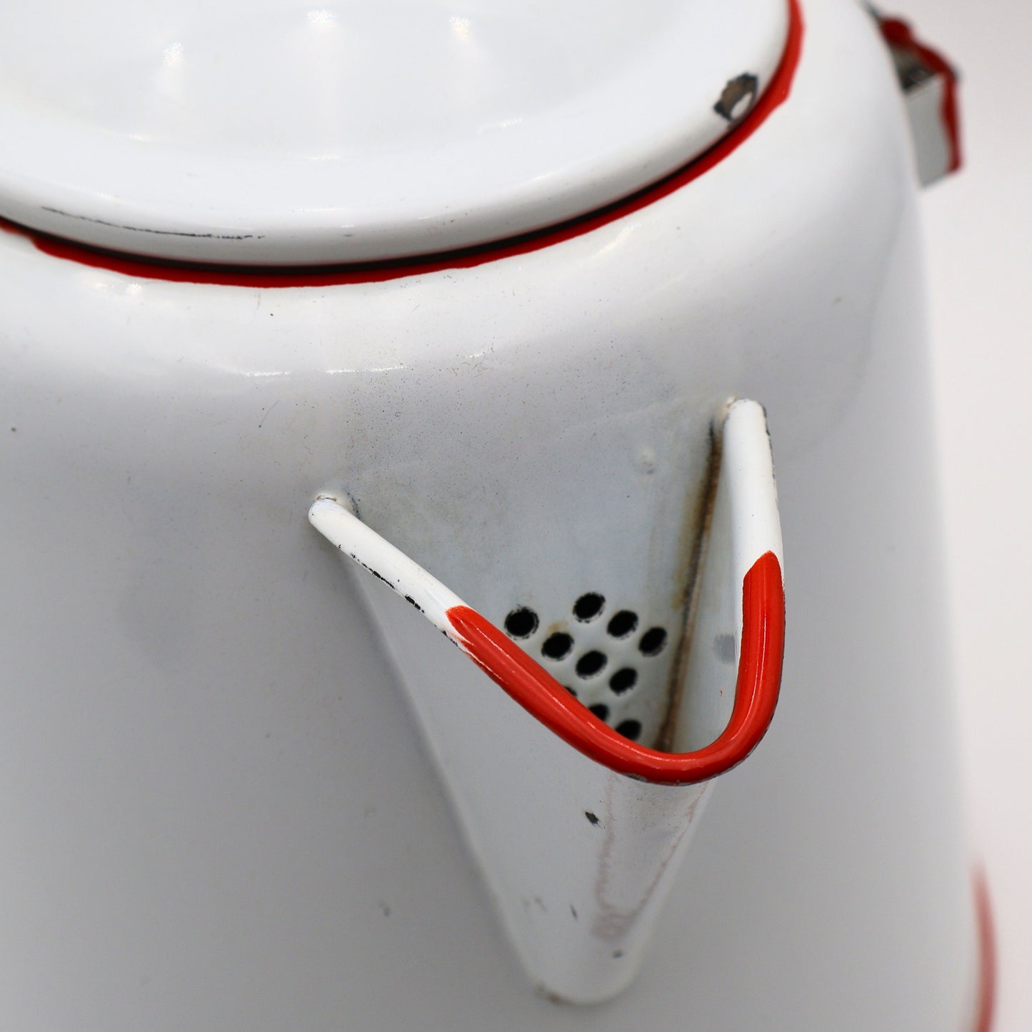 Detail view of vintage enamel coffee pot showing red trimmed spout and classic ranch styling