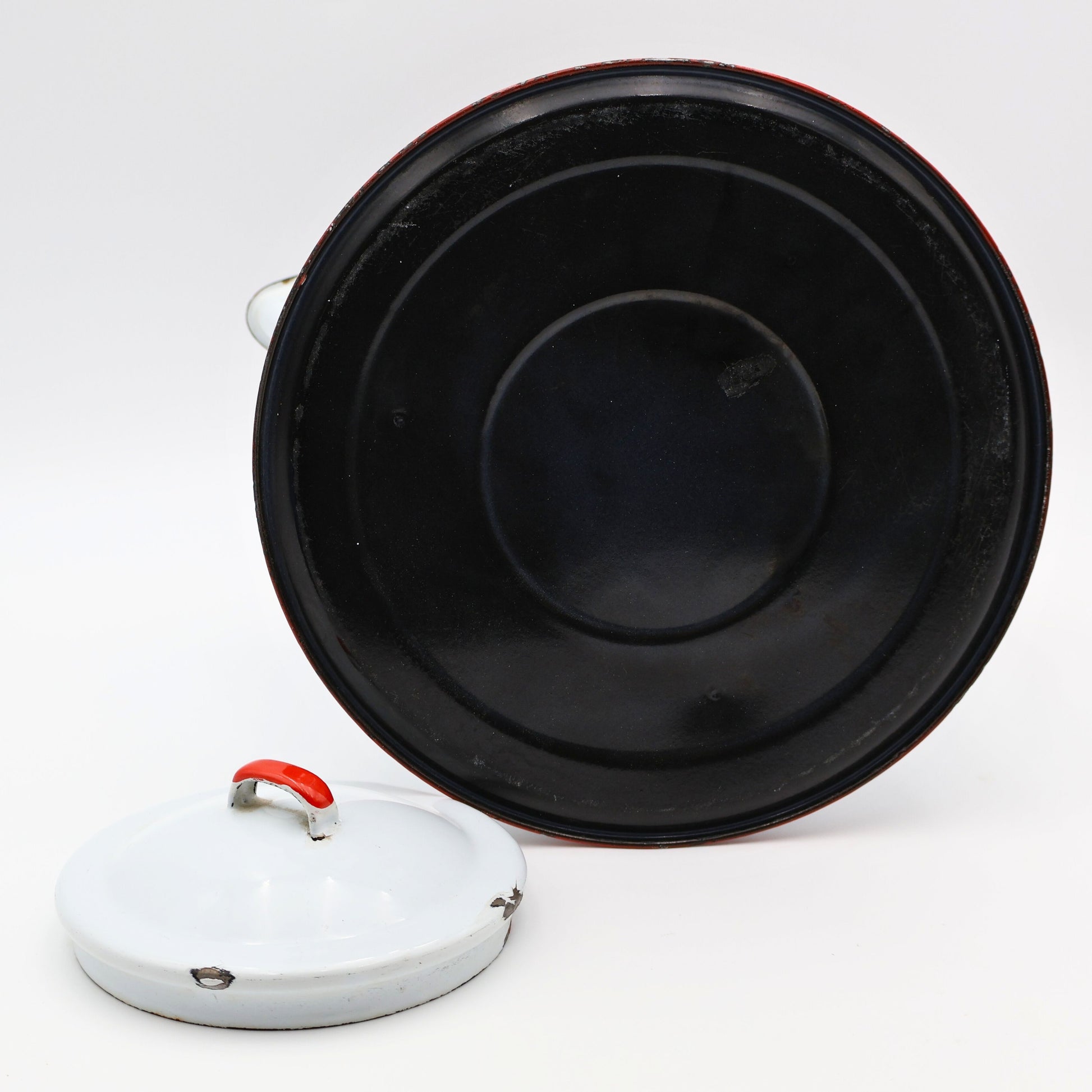 Bottom view of large vintage enamel coffee pot with blackened interior base from age