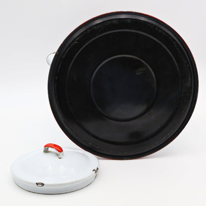 Bottom view of large vintage enamel coffee pot with blackened interior base from age