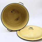 Vintage yellow enamelware stock pot displayed with the lid removed, revealing the enamel-coated interior with authentic vintage wear from years of everyday use. A charming farmhouse collectible with timeless rustic appeal.