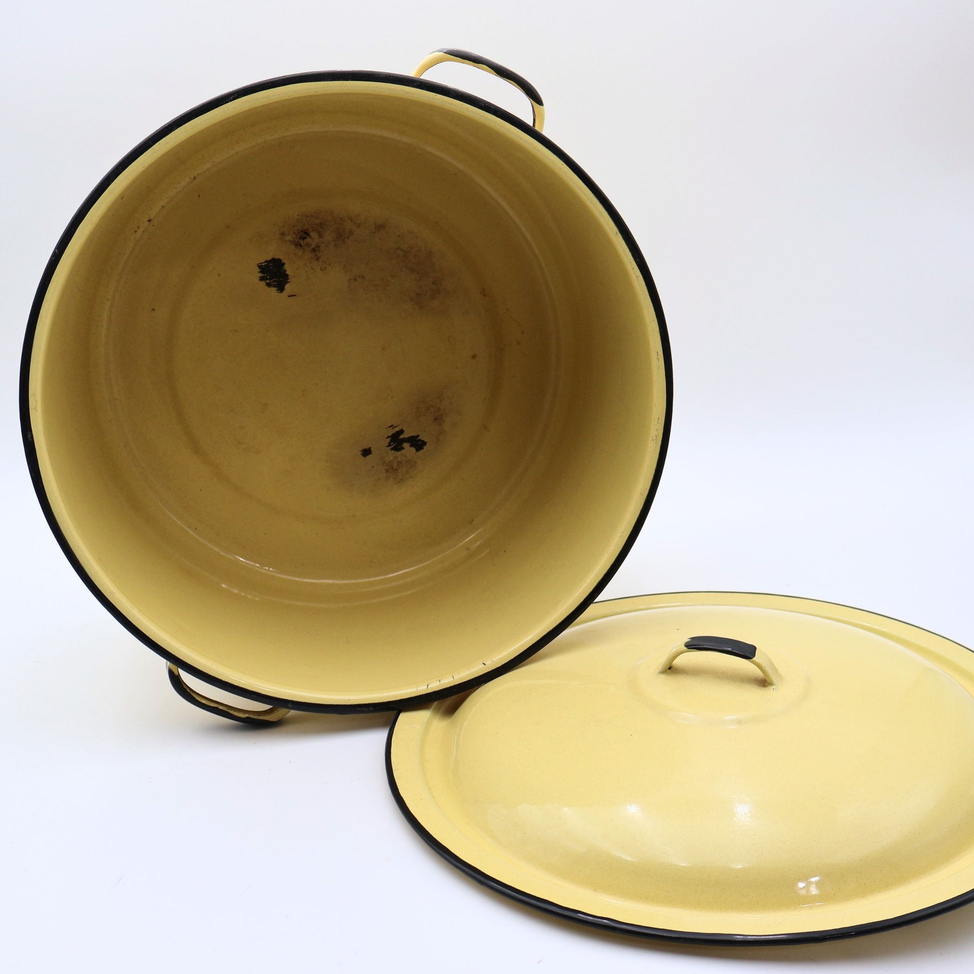 Vintage yellow enamelware stock pot displayed with the lid removed, revealing the enamel-coated interior with authentic vintage wear from years of everyday use. A charming farmhouse collectible with timeless rustic appeal.