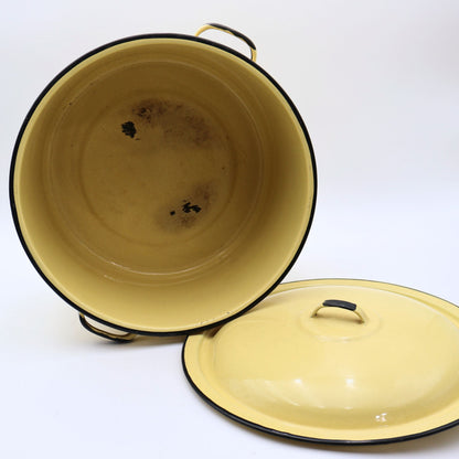 Vintage yellow enamelware stock pot displayed with the lid removed, revealing the enamel-coated interior with authentic vintage wear from years of everyday use. A charming farmhouse collectible with timeless rustic appeal.