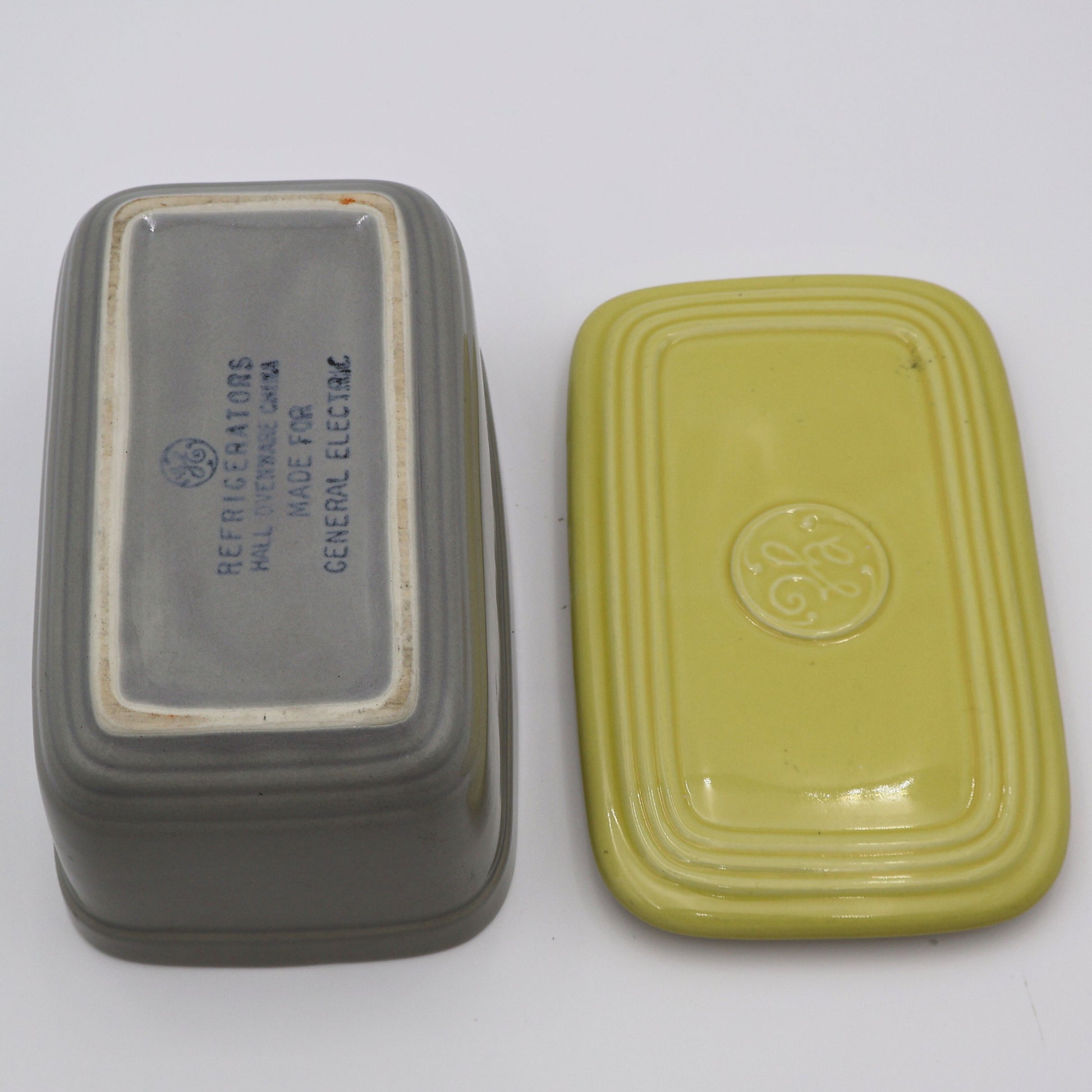 Open vintage GE refrigerator dish with lid showing makers mark and mid century design.