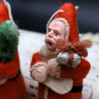 Side angle view of vintage German Belsnickle Santa ornaments highlighting dimensional handmade construction