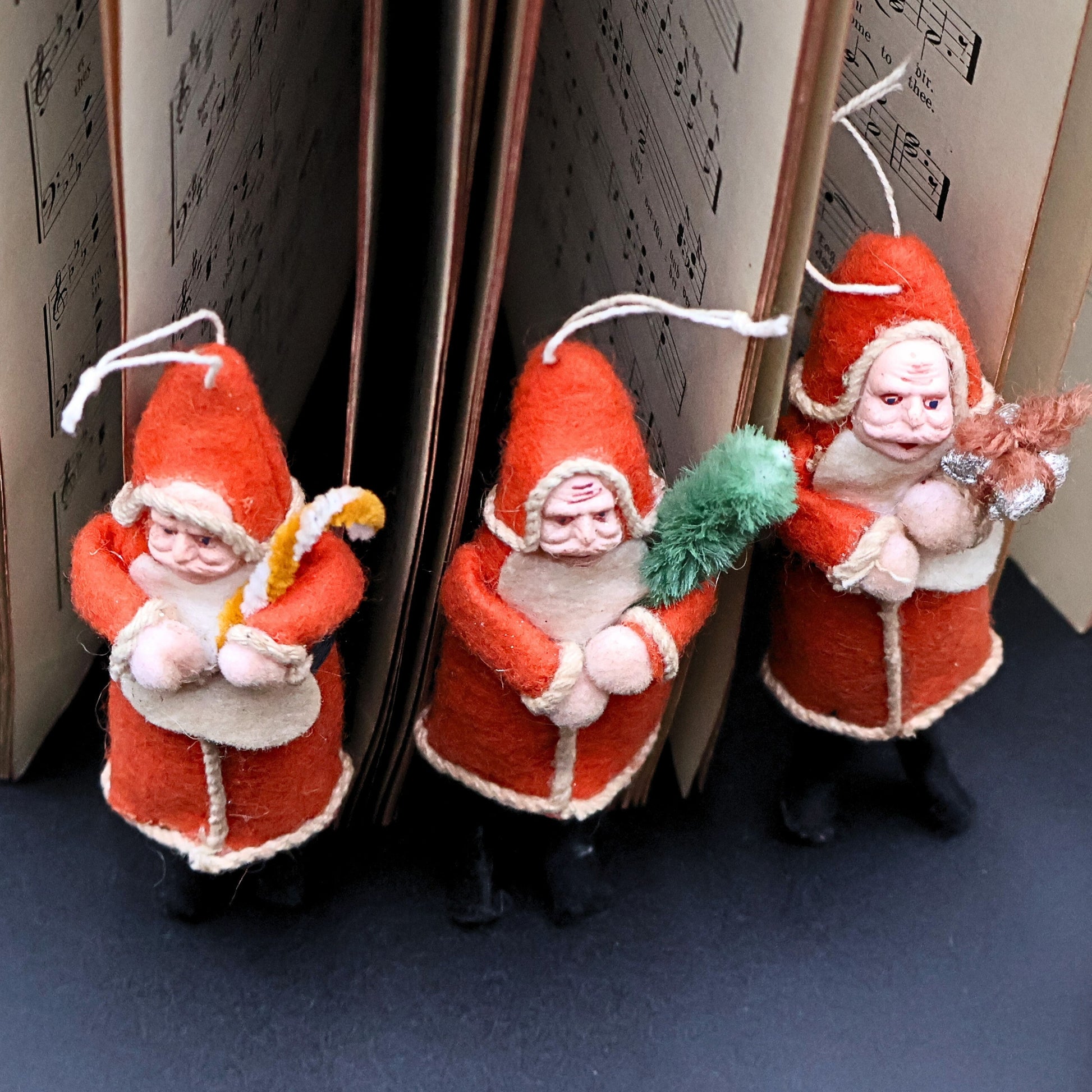 Vintage German Santa ornaments set displayed together as holiday decor with classic folk art styling