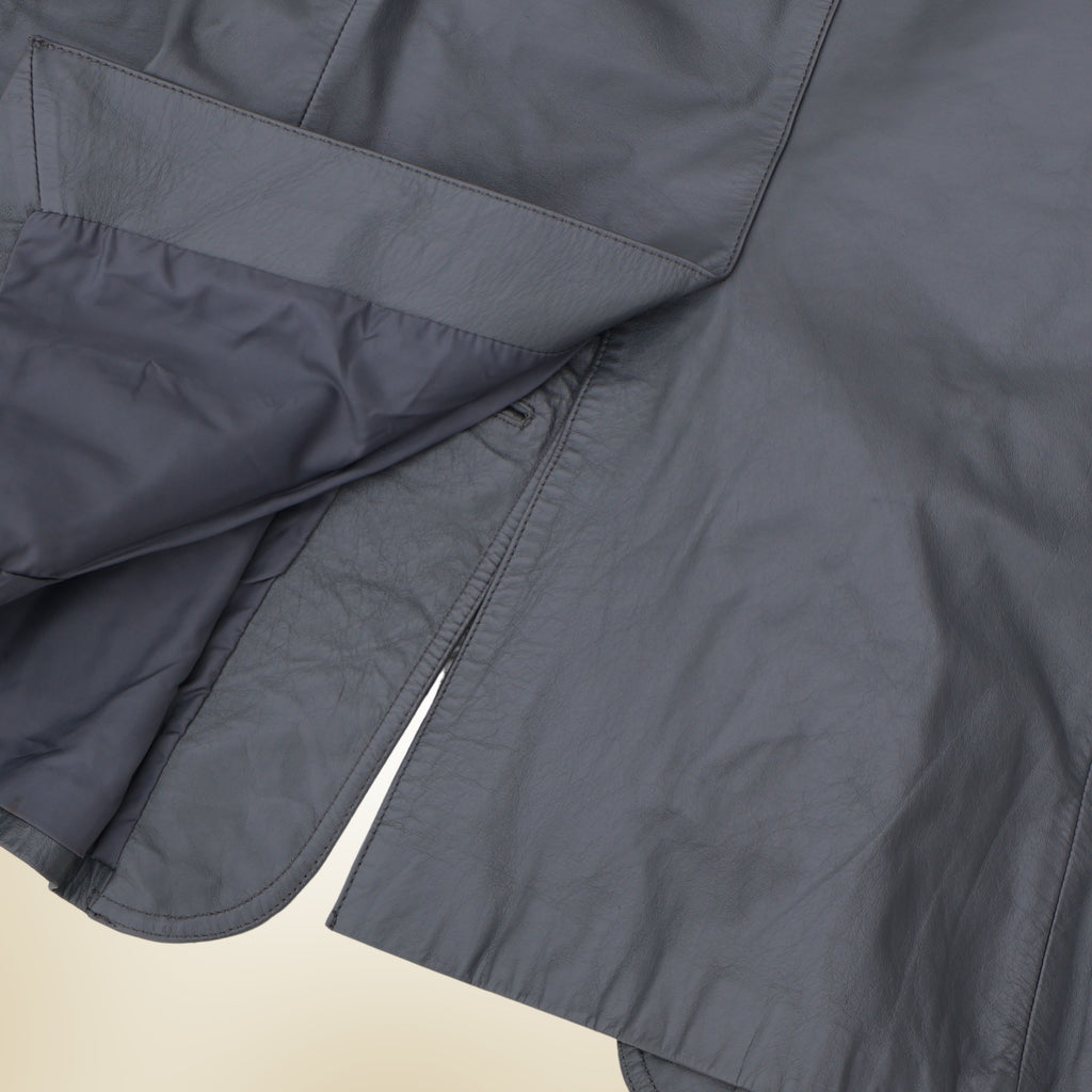 Exterior back detail of vintage gray leather blazer with tail slit and lining.