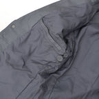 Close up of gray leather blazer front pocket with stitched leather trim and soft lining.