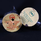 Close-up of the original paper base labels on two vintage Gurley turkey candles. Green and red printing identifies Gurley Novelty Company of Buffalo, New York, shows the 10-cent price and warns that air currents may cause dripping while the candles are burning.