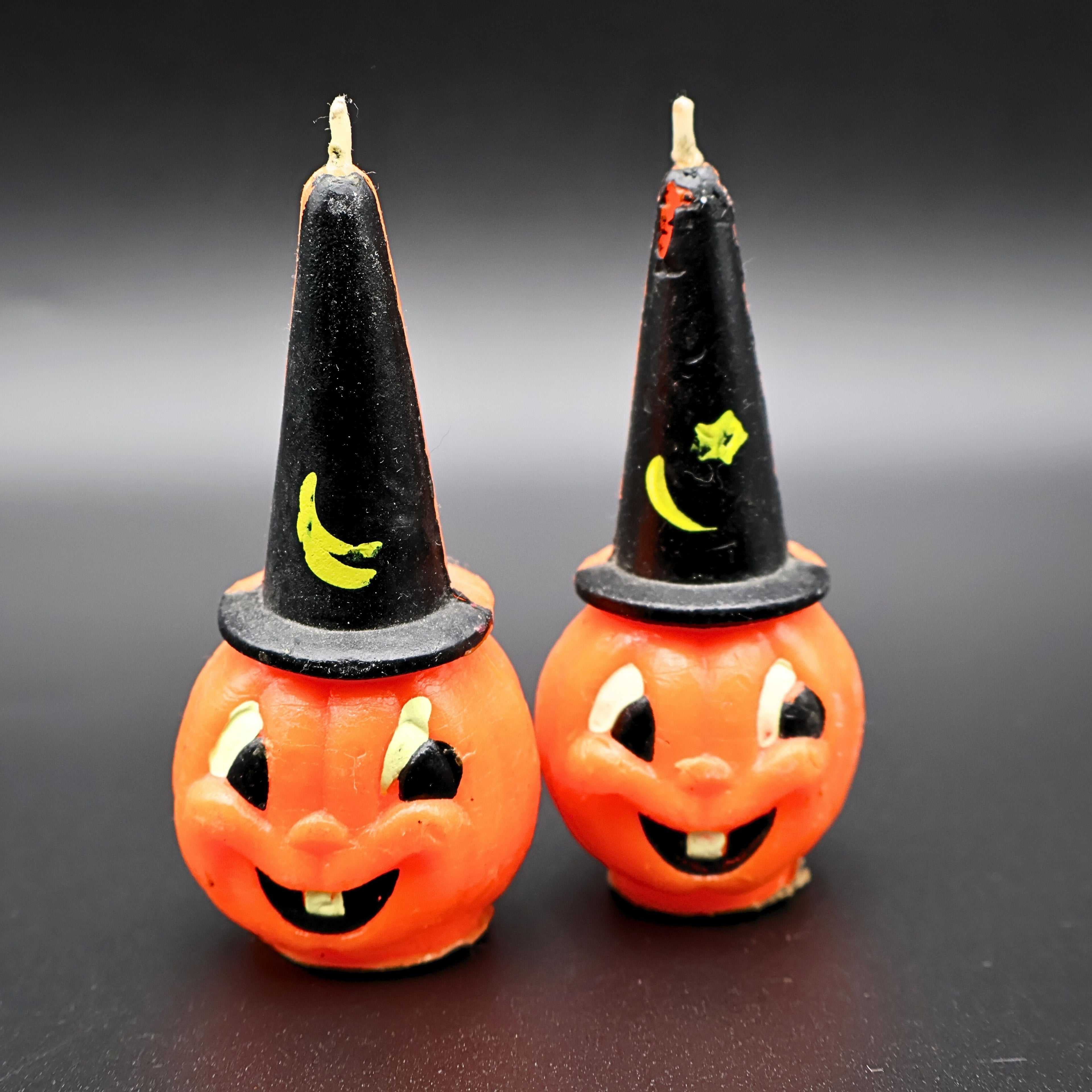Vintage Gurley pumpkin candle set with witch hats, front view of mid century Halloween jack o lantern pair