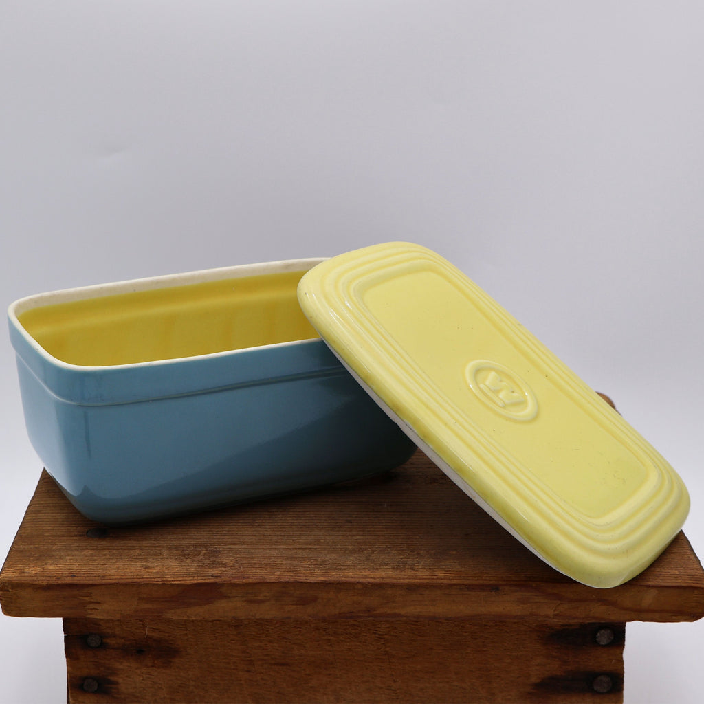 Vintage Hall China Westinghouse refrigerator dish showing butter yellow interior and original lid.