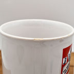 Close-up photograph of the upper rim of the vintage Jamaica souvenir mug documenting minor glaze wear and small areas of finish loss from age and previous use. This detailed condition image helps collectors evaluate the ceramic mug before purchase.