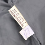 Interior care tag of vintage leather blazer indicating leather requires specialized cleaning.