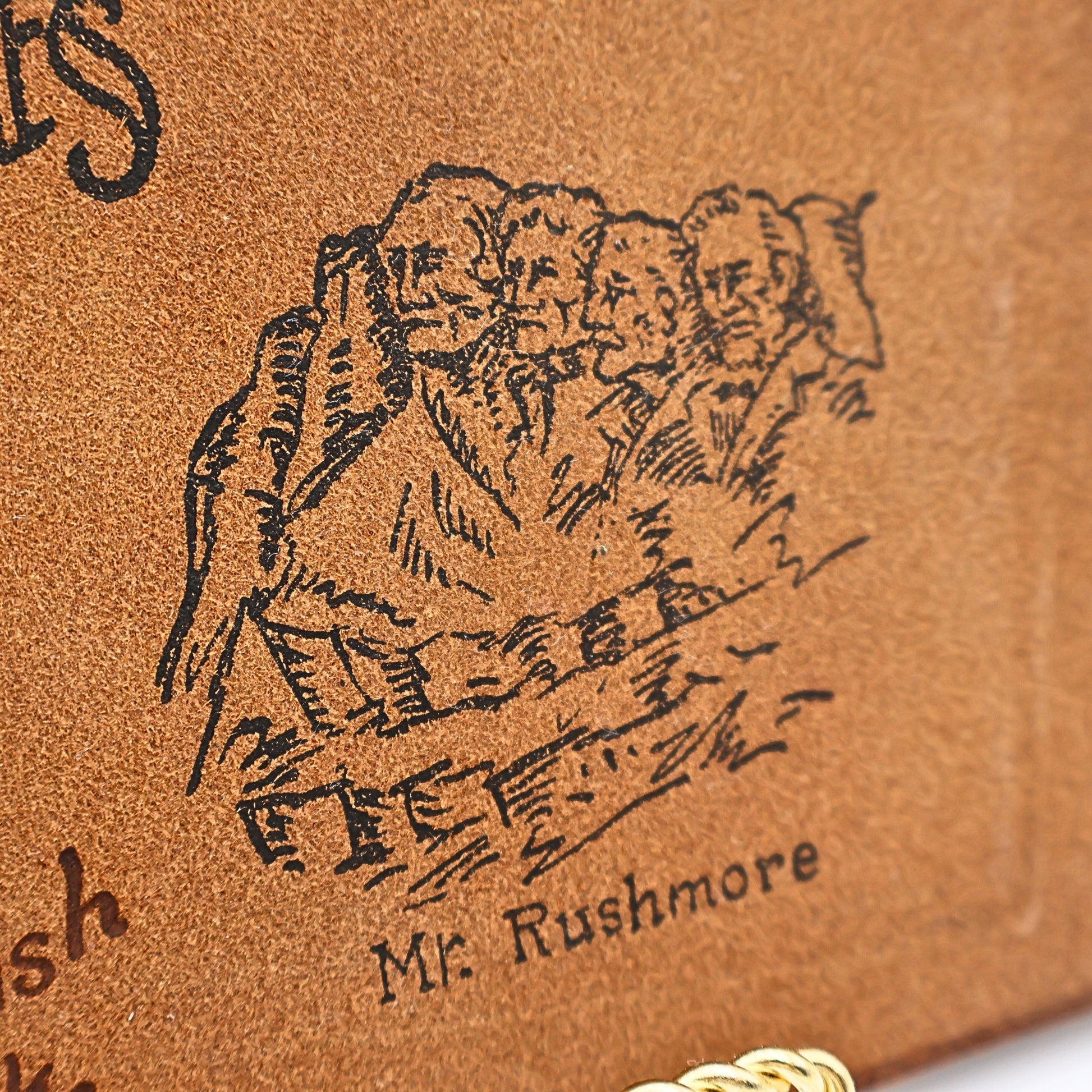 Mount Rushmore stamped artwork on vintage leather photo album