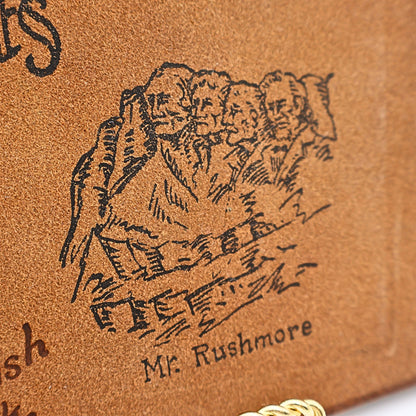 Mount Rushmore stamped artwork on vintage leather photo album