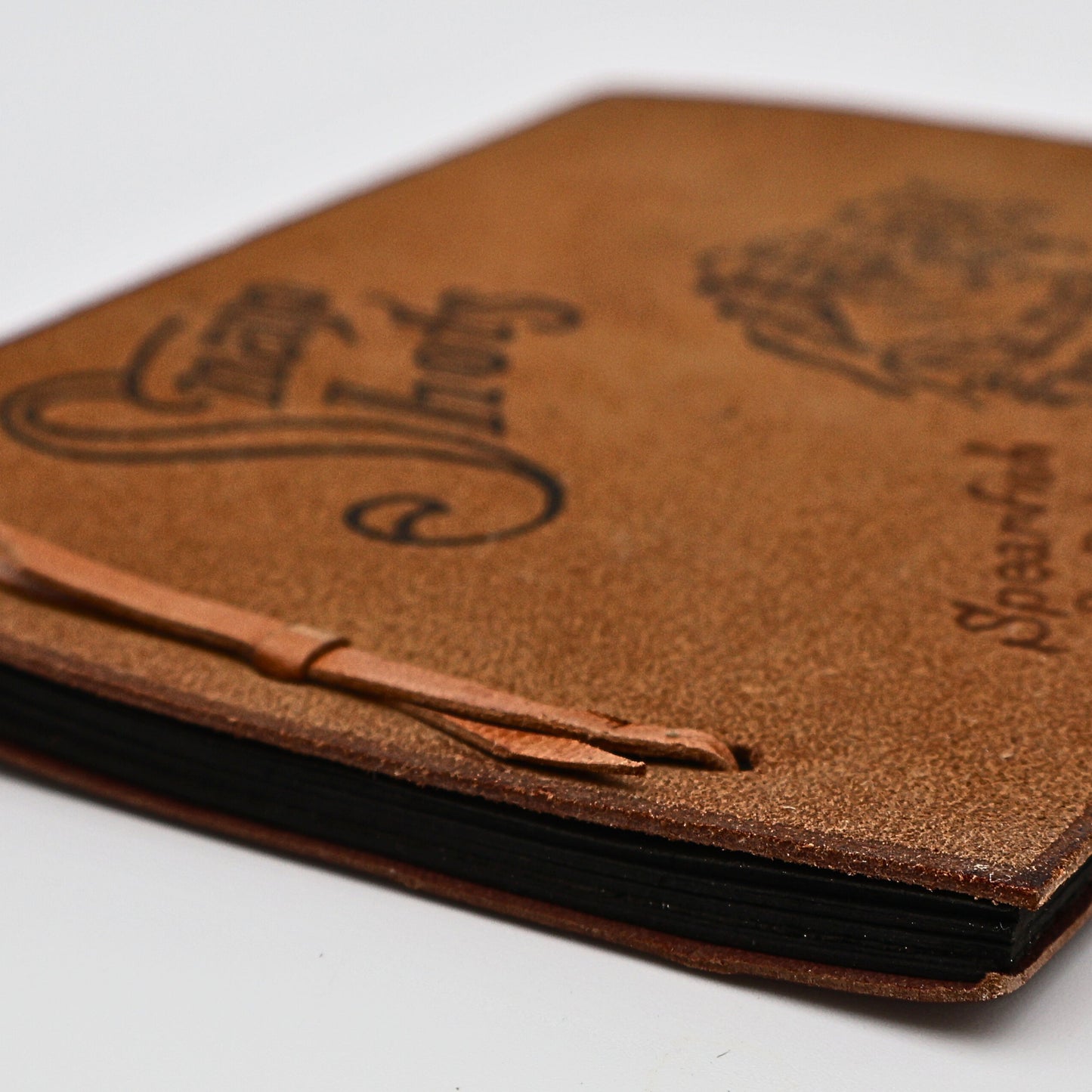 Side view and binding of vintage leather Snap Shots photo album