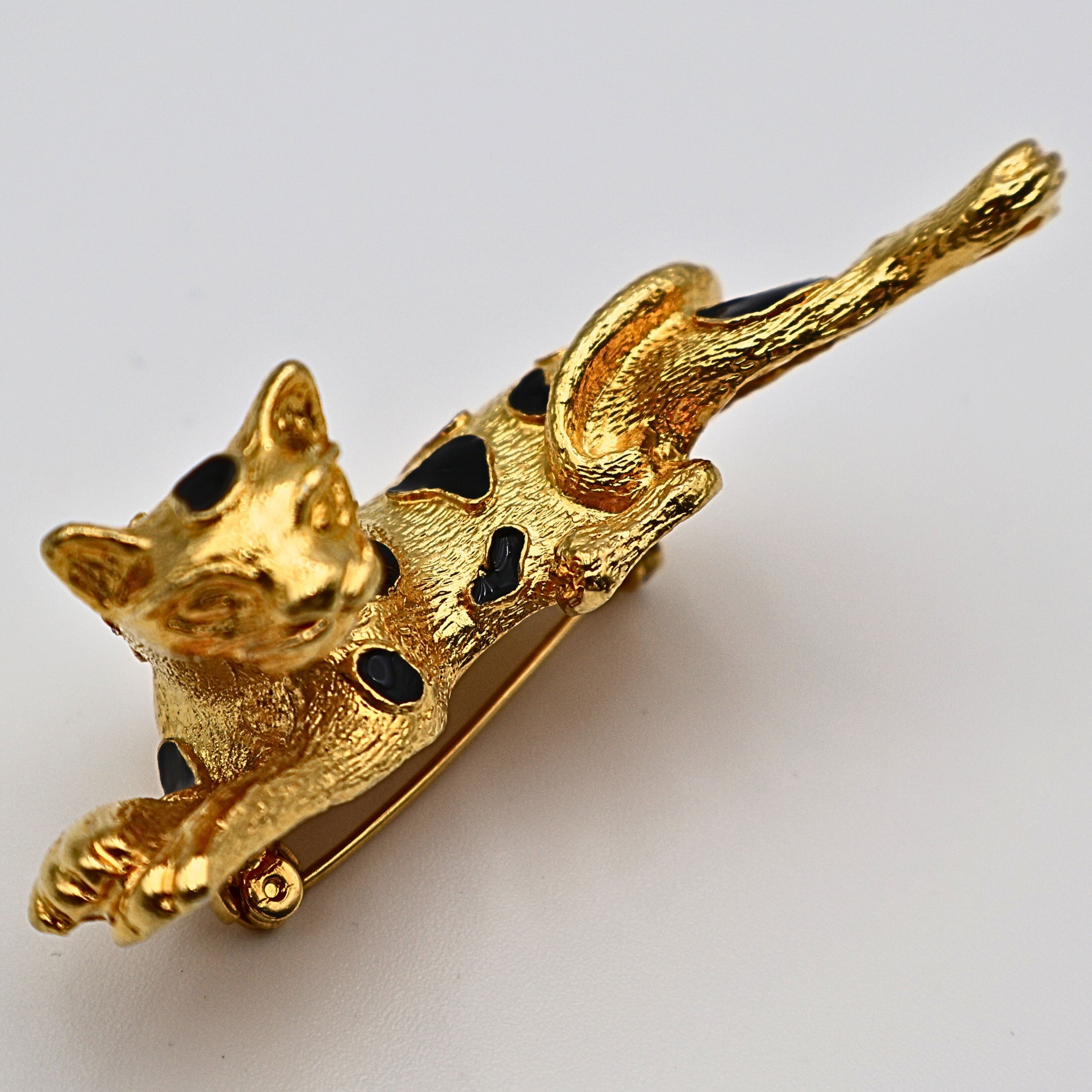Close-up of black enamel detailing on vintage leopard brooch pin