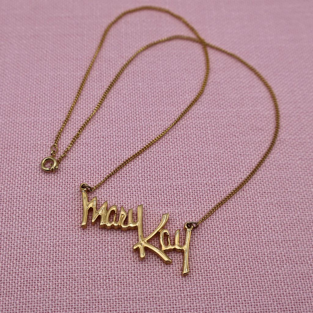 Full view of vintage Mary Kay Lady gold tone necklace with delicate chain and script pendant, classic direct sales jewelry.