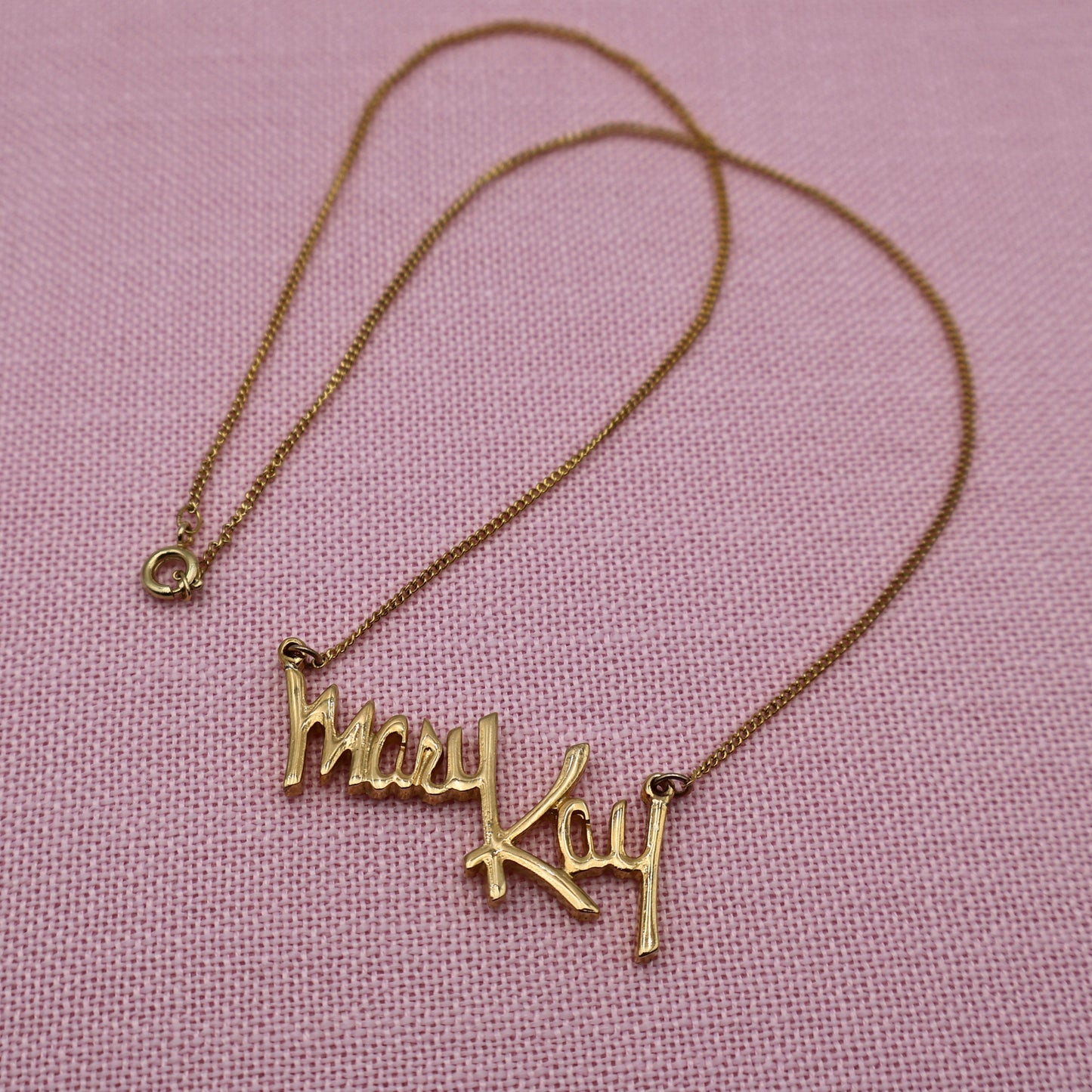 Full view of vintage Mary Kay Lady gold tone necklace with delicate chain and script pendant, classic direct sales jewelry.
