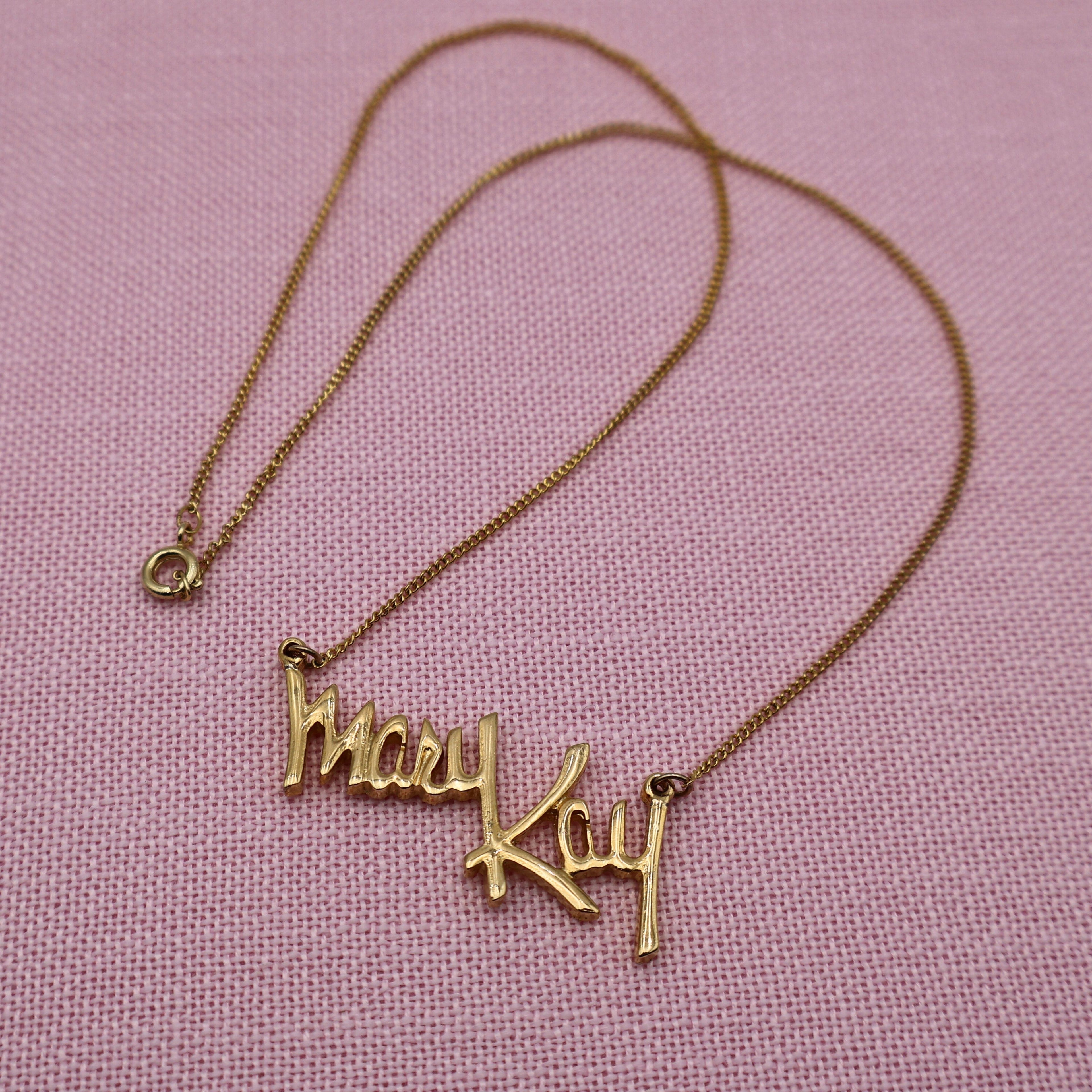 Full view of vintage Mary Kay Lady gold tone necklace with delicate chain and script pendant, classic direct sales jewelry.