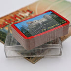 Vintage Mount Rushmore souvenir playing cards resting inside the original clear plastic display case. The unopened deck showcases the scenic Mount Rushmore card back artwork while highlighting its preserved condition and nostalgic roadside souvenir charm.