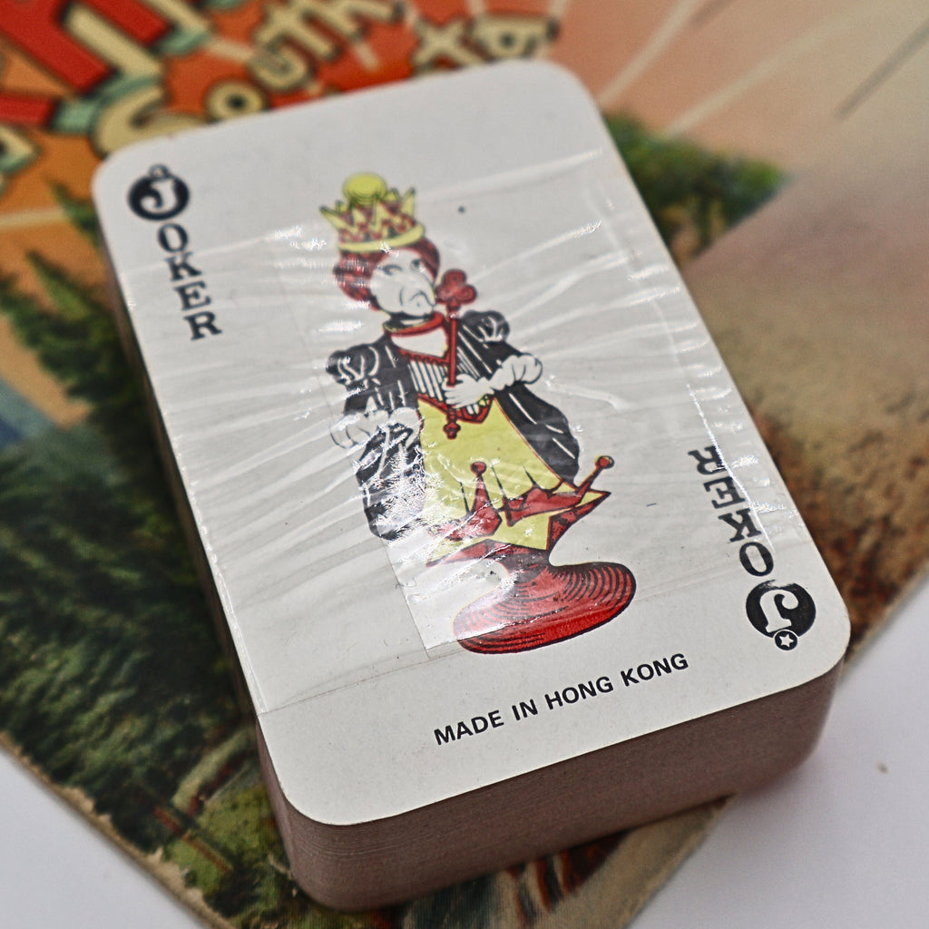 Back of the vintage souvenir playing card deck featuring the Joker card with colorful court illustration and "Made in Hong Kong" printed below. The unopened deck remains wrapped in its original plastic, confirming its vintage travel souvenir origins.