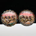 Pair of vintage Mount Rushmore clip-on earrings featuring raised sculpted presidential portraits beneath clear domed covers. The gold-tone scalloped settings frame colorful copper, bronze, green, and rose scenic details, highlighting classic mid-century South Dakota souvenir jewelry displayed from the front.