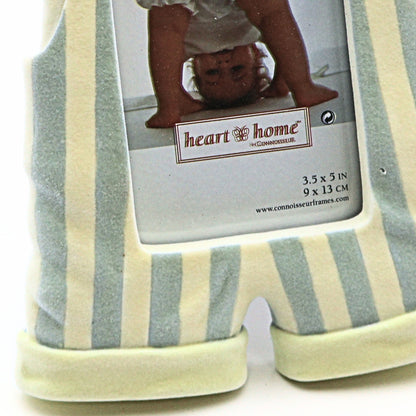 Detailed closeup of vintage baby nursery picture frame showing striped romper legs 3.5x5 photo display opening and flocked resin construction for keepsake decor