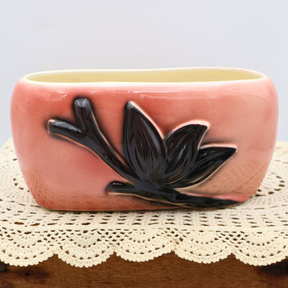 Vintage Royal Copley pink ceramic planter with raised black leaf design, mid-century modern pottery from Ohio.