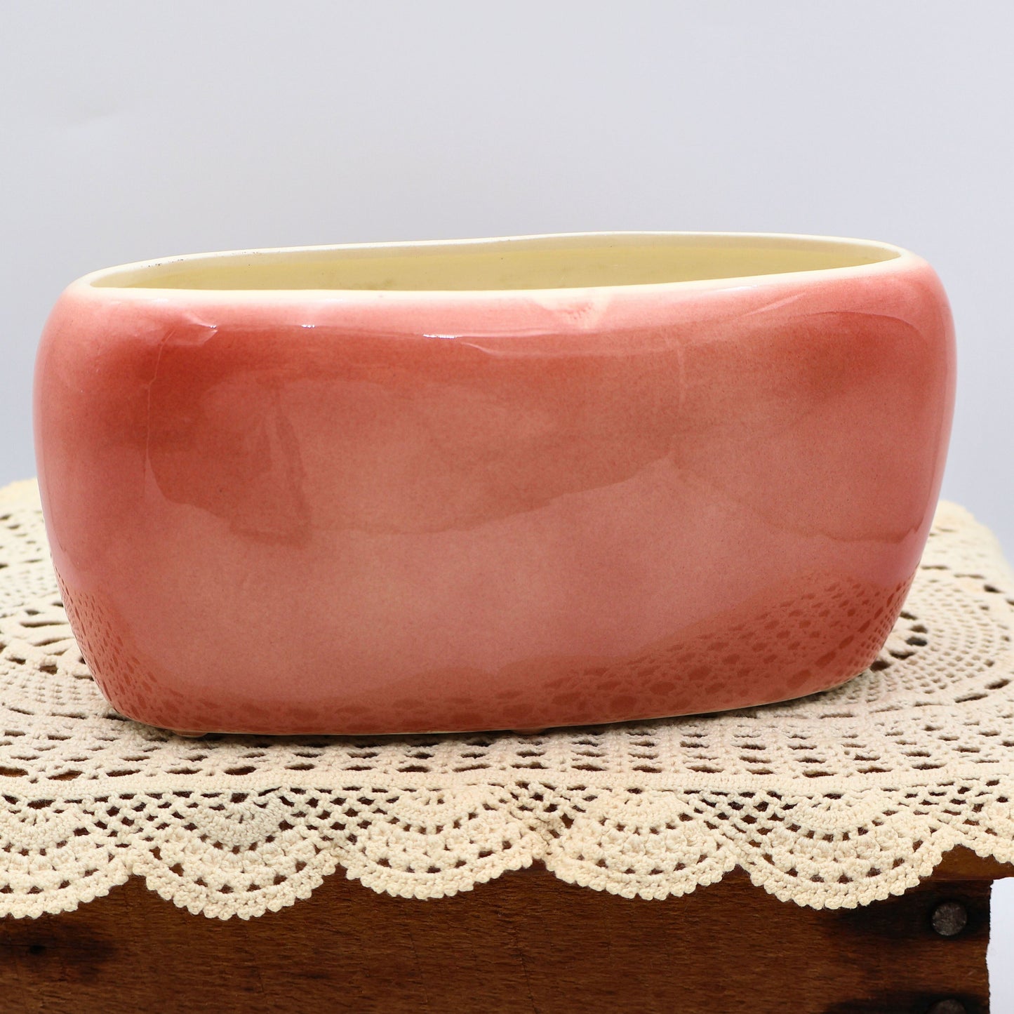 Back view of vintage Royal Copley planter showing glossy blush pink glaze and oval mid-century shape.